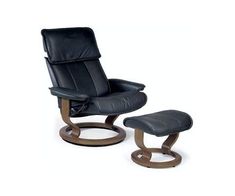 a black leather reclining chair and footstool with wooden feet rest on an isolated white background