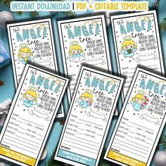 three printable angel baby shower game cards with christmas decorations on the table and blue background