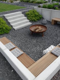 an outdoor seating area with wooden benches and stone steps