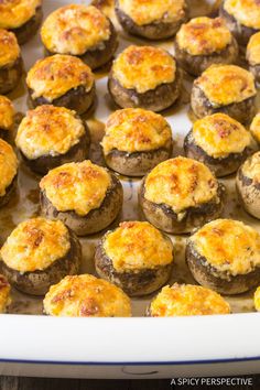 baked mushrooms with cheese on top in a baking dish, ready to be eaten or served