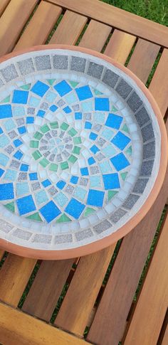 a bowl sitting on top of a wooden bench