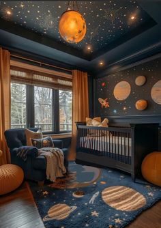 a baby's room decorated in blue and orange with stars on the ceiling, planets hanging from the ceiling