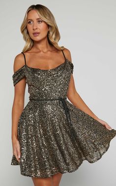 Get ready to turn heads at your next party night with the Keke Mini Dress! This playful and flirty dress features a strappy off-shoulder design and a sexy cowl neck that will make you feel like the life of the party. The A-line silhouette adds a touch of femininity, while the shimmering gold color adds an extra dash of glam. Made from polyester, this sleeveless mini dress is not only stylish but also comfortable to wear all night long. Perfect for dancing the night away or making a statement at Gold Mini Dress With Sweetheart Neckline, Gold V-neck Mini Dress For Formal Occasions, Glamorous A-line Mini Dress With Sequins, Chic Gold A-line Mini Dress, Gold Party-ready Evening Mini Dress, Basic Black Dress, Spring Maxi Dress, Bachelorette Dress, Neon Outfits