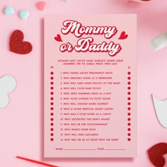 a pink card with the words mommy and daddy on it next to confetti