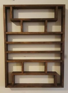 a wooden shelf sitting on top of a white wall