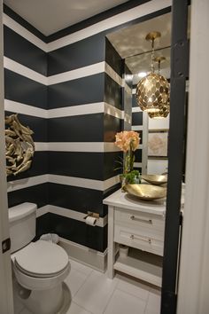 a bathroom with black and white striped walls