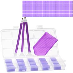 a set of purple tools in a plastic container with dividers and trays on the side