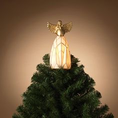 a small christmas tree with an angel decoration on it's top and lights in the middle