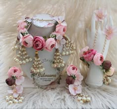 pink flowers and pearls are on display in front of a mannequin