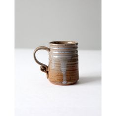 a brown and white mug sitting on top of a table