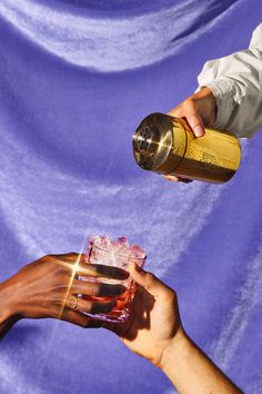 two people are holding wine glasses and one is pouring them into the other's hand