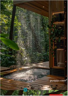 an outdoor shower in the middle of a garden with lots of greenery and trees