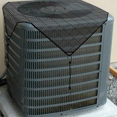 an air conditioner sitting on top of a cement block