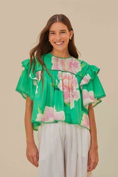 Embrace the vibrancy of the season with the Green Floral Vibing Blouse, a lively symphony of bright green hues and whimsical floral prints. This alluring piece features a round neckline complemented by fluttering ruffle sleeves and a delicate trim. The soft, flowing cut creates a playful yet refined silhouette that dances with each step. Perfect for infusing your wardrobe with a touch of tropical charm and effortless elegance. Composition 100% COTTONCare Instructions MACHINE WASH DELICATE CYCLE, DO NOT BLEACH, DO NOT TUMBLE DRY, LINE DRYING, IRON AT MEDIUM HEAT, DRY CLEAN WITH ANY SOLVENT EXCEPT TRICHLOROETHYLENESize and Fit Inches XXS XS S M L XL Bust 41 3/4 43 3/4 45 3/4 47 3/4 50 3/4 54 Waist 39 3/4 40 3/4 41 3/4 42 3/4 44 1/4 45 3/4 Length 20 20 3/4 21 1/4 21 3/4 22 2/4 23 Hip N/A N/A Green Vibrant Print Summer Blouse, Summer Green Blouse With Vibrant Print, Vibrant Printed Green Tops, Summer Blouse With Vibrant Green Print, Vibrant Green Printed Tops, Green Ruffled Tops For Summer, Vibrant Floral Print Short Sleeve Tops, Green Printed Spring Tops, Green Floral Print Short Sleeve Top