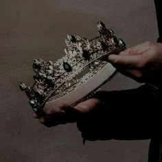 a person holding a crown in their hand