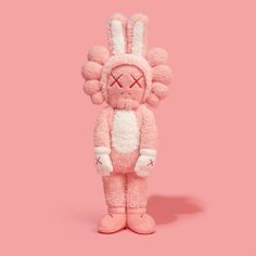 a pink bunny stuffed animal standing in front of a pink background