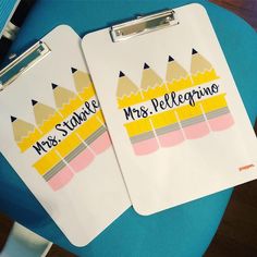 two white clipboards with yellow and pink crayons on them that say mr and mrs pelegonie