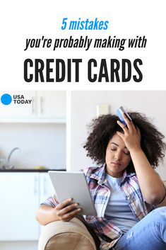 a woman sitting on a couch with her head in her hands while looking at a credit card