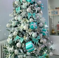 a decorated christmas tree with blue and white ornaments