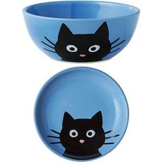 two blue bowls with black cats painted on the front and back of them, one bowl has a cat's face drawn on it