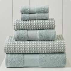 four towels stacked on top of each other in blue and white checkered pattern,