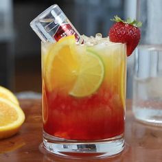 a drink with lemons and strawberries on the table