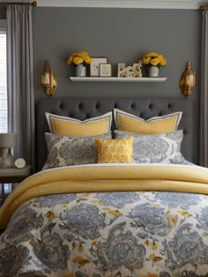 a bedroom with gray walls and yellow accents