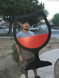 a man is standing in front of a sculpture