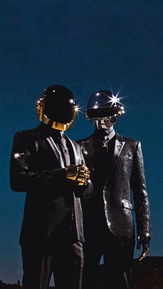 two mannequins dressed in black suits and gold helmets standing next to each other