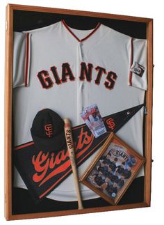 the san francisco giants baseball uniform is displayed in a shadow box with an autographed baseball bat