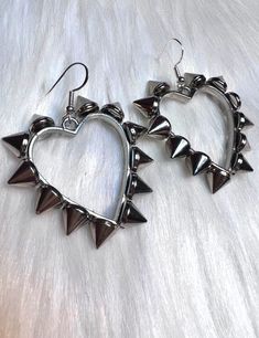 These awesome spiked earrings are part of our new Valentine's Day Collection. It's packed full of beautiful pieces.  These are  Silver hearts with shiny spikes all the way around on small silver hooks. Big Funky Earrings, Silver Studs Jewelry For Party, Silver Stud Jewelry For Parties, Silver Gothic Earrings For Valentine's Day, Edgy Silver Studs Jewelry, Silver Punk Jewelry For Valentine's Day, Punk Silver Jewelry For Valentine's Day, Edgy Silver Metal Plug Earrings, Edgy Spiked Jewelry For Parties