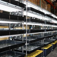 several shelves filled with lots of different types of clocks and other items in bins