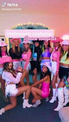 a group of women dressed in costumes posing for a photo at a halloween costume party