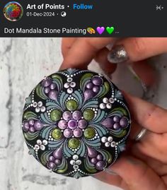 someone is holding a painted rock in their hand and it looks like they are going to paint