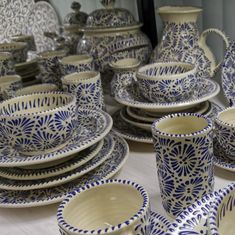 a table topped with lots of blue and white dishes