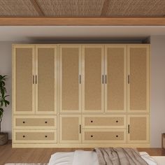 a bed sitting under a wooden ceiling next to a wall mounted cabinet with drawers and doors