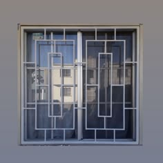 a cat sitting on the window sill in front of a building with windows and bars