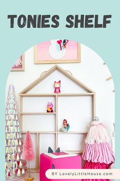 a pink suitcase sitting on top of a wooden floor next to a shelf filled with toys