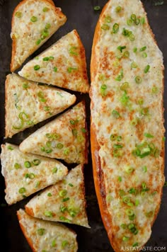 four pieces of pizza with cheese and green onions