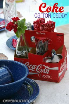 there is a coca - cola carton caddy on the table