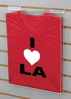 a red t - shirt with the word i love la printed on it and a white heart