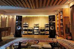 a living room filled with lots of furniture and speakers