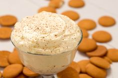 a dessert in a glass bowl with cookies around it