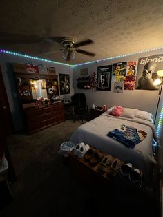 a bed room with a neatly made bed and lots of clutter on the floor