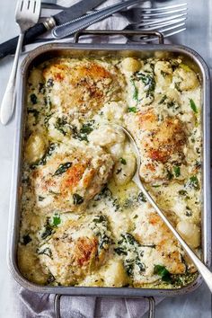 chicken and spinach casserole in a pan with a spoon on the side