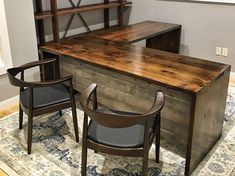 an office with two chairs and a desk in the middle of it, along with a rug on the floor