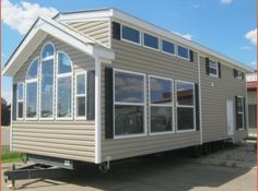 a tiny house sitting on the back of a trailer