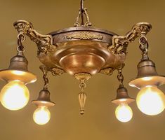 a chandelier with five lights hanging from it