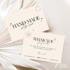 two business cards with the words handmade and thank you written on them, sitting next to each other