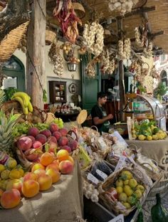 an outdoor market with fruits and vegetables on display